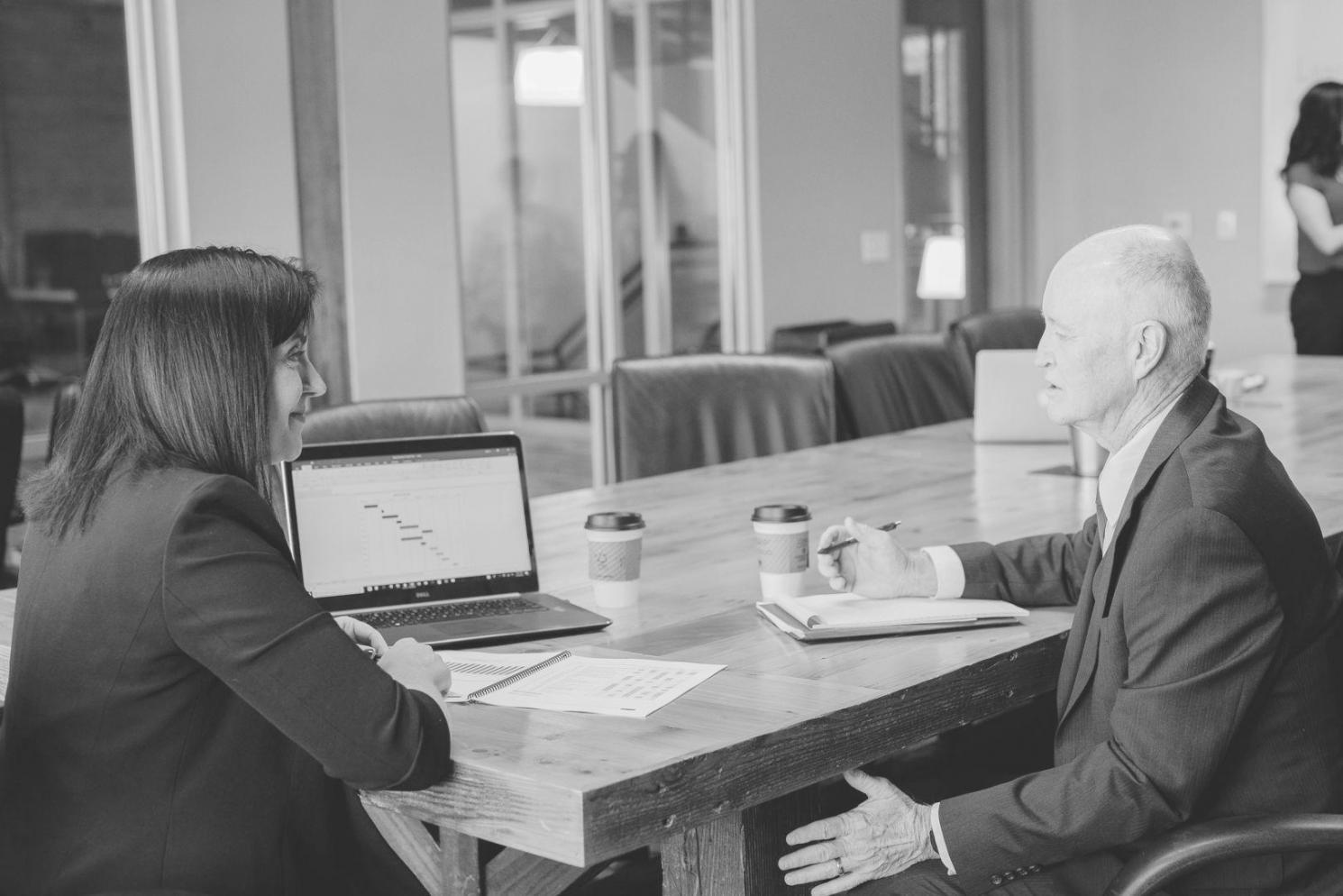 Person reviewing financial documents with notebook and calculator